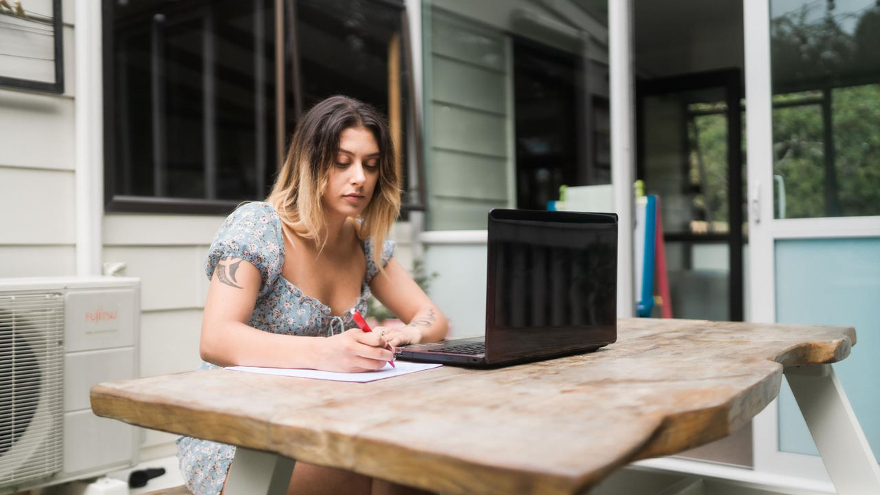 A UC Online student uses a laptop to research scholarships, StudyLink, and other ways to fund her online learning.