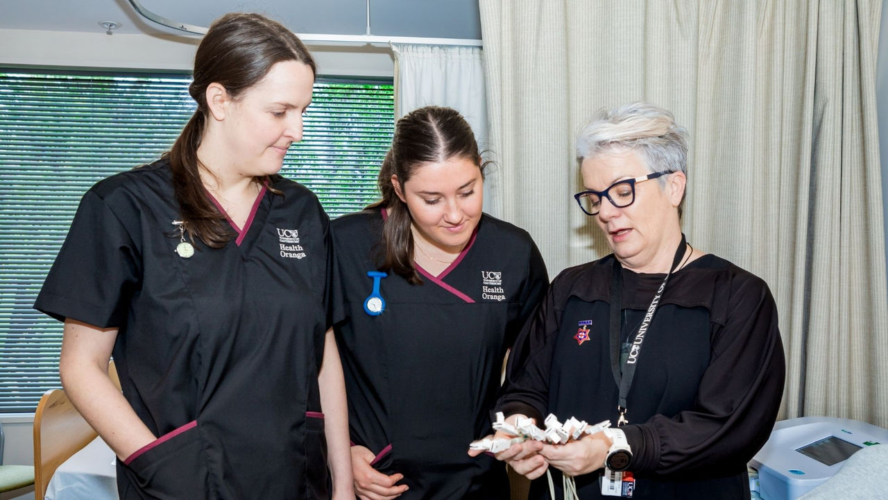 Two nursing students learning from an expert lecturer on-campus as part of the flexible Master of Health Sciences (Nursing)