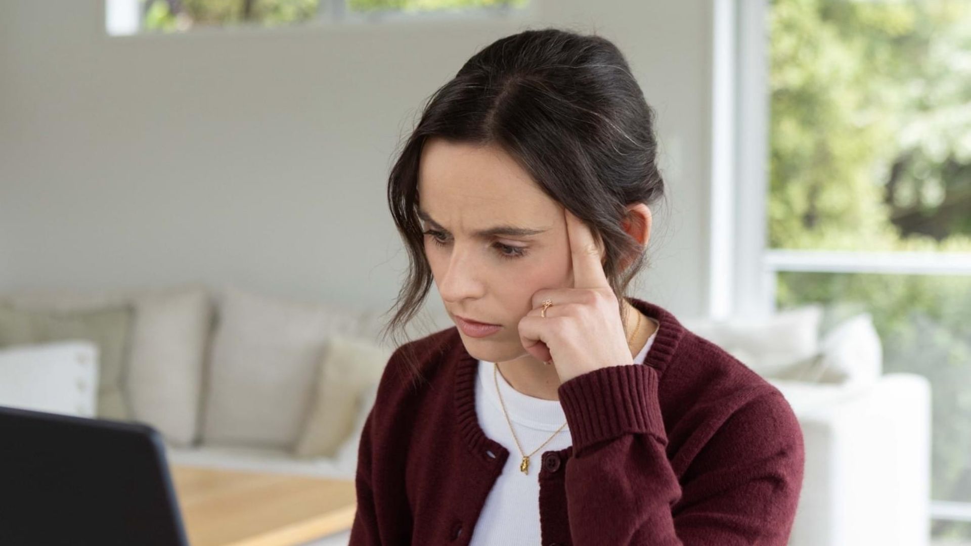 Woman sitting at her computer, looking confused about online study
