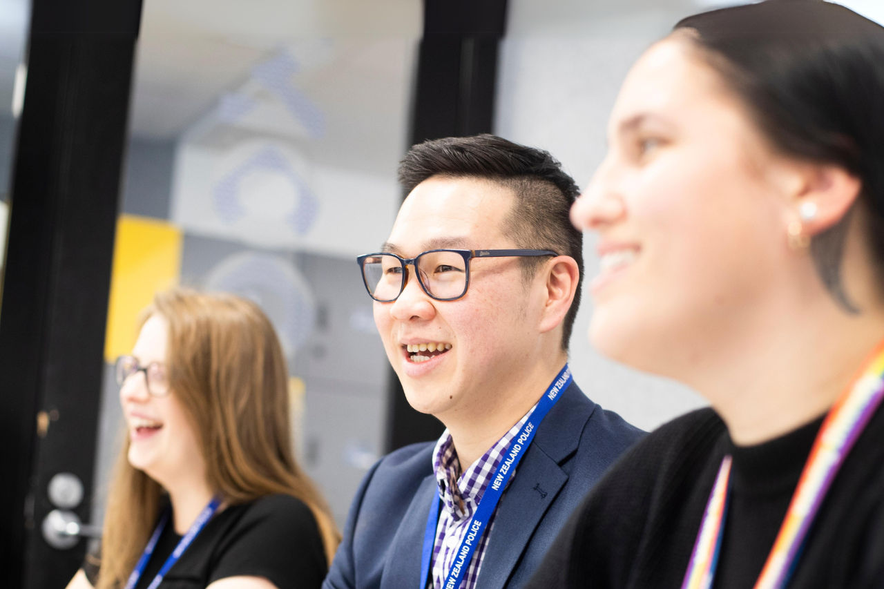 A graduate of the UC Online Certificate in Criminal Justice programme takes part in a positive, energised boardroom meeting.