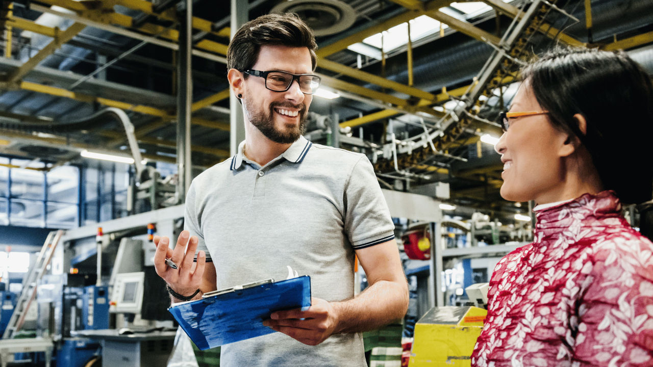 Two people standing in an engineering warehouse