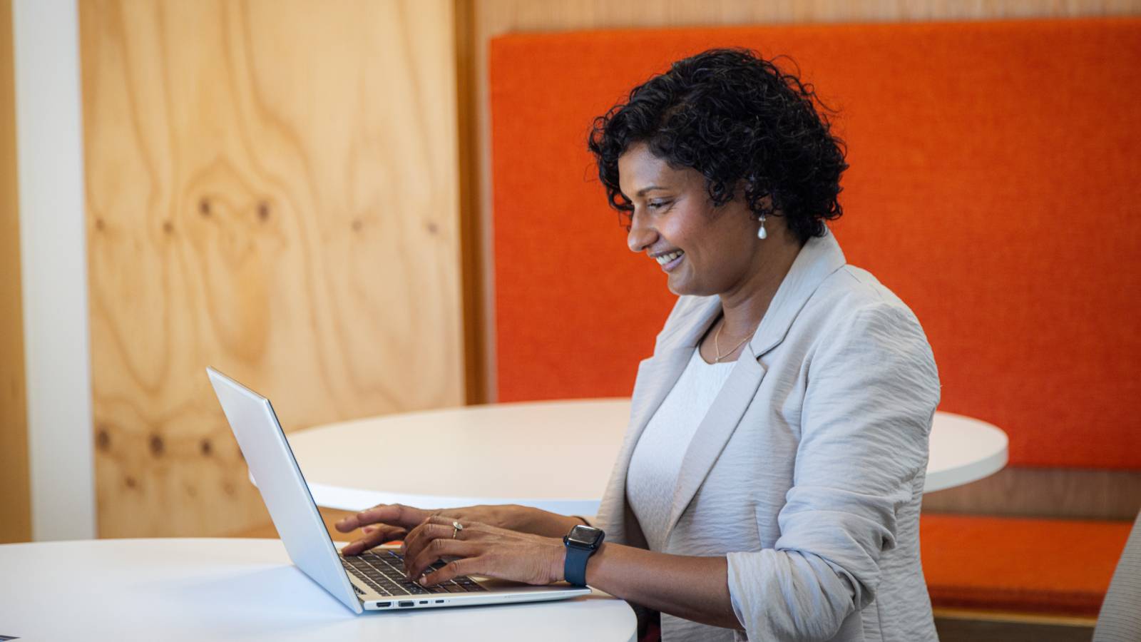 Female manager sits at computer, upskilling in employment law online