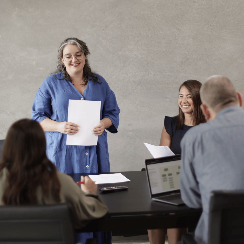A woman presenting a risk management framework to her colleagues