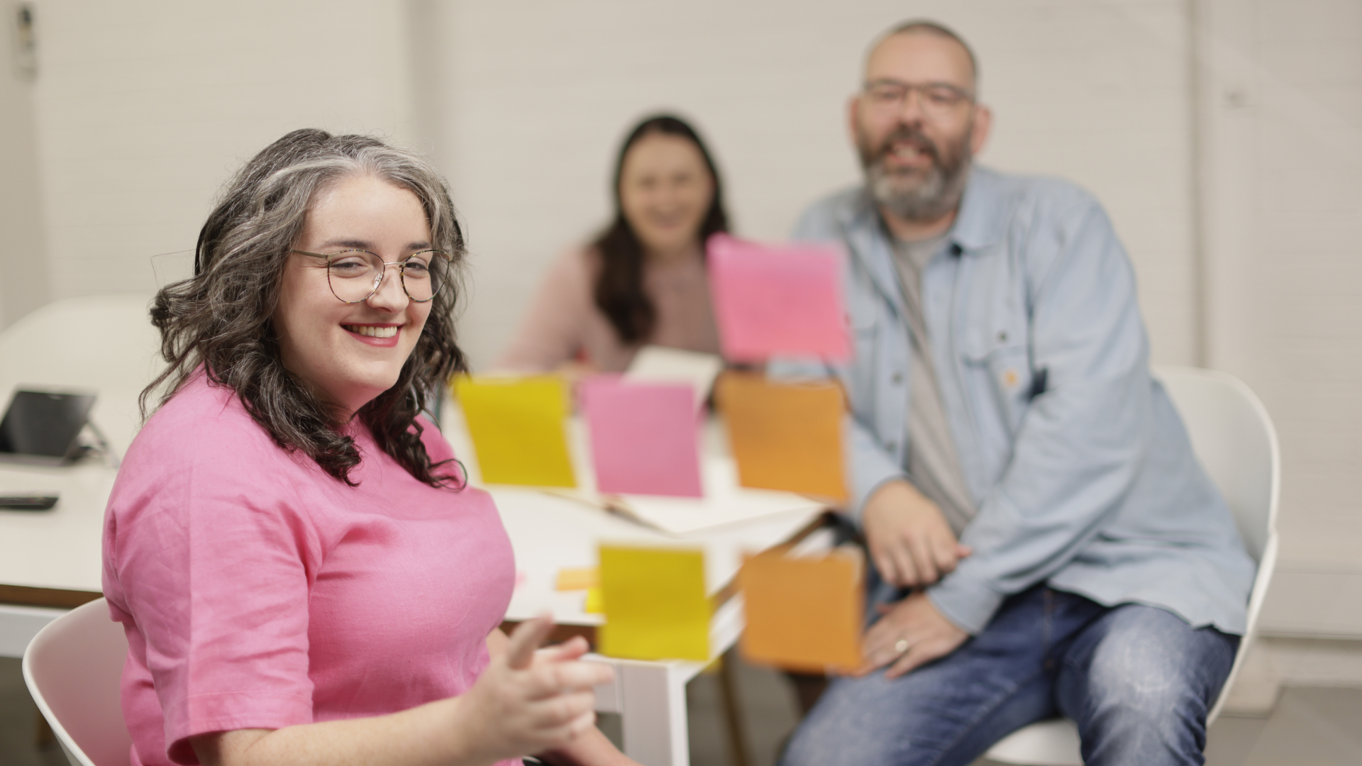 Woman showcasing data trends in an office, after upskilling with online data science courses. 