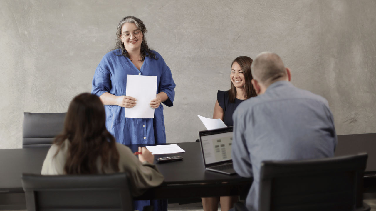 Woman presents applied data science findings in a meeting as part of her postgrad diploma study