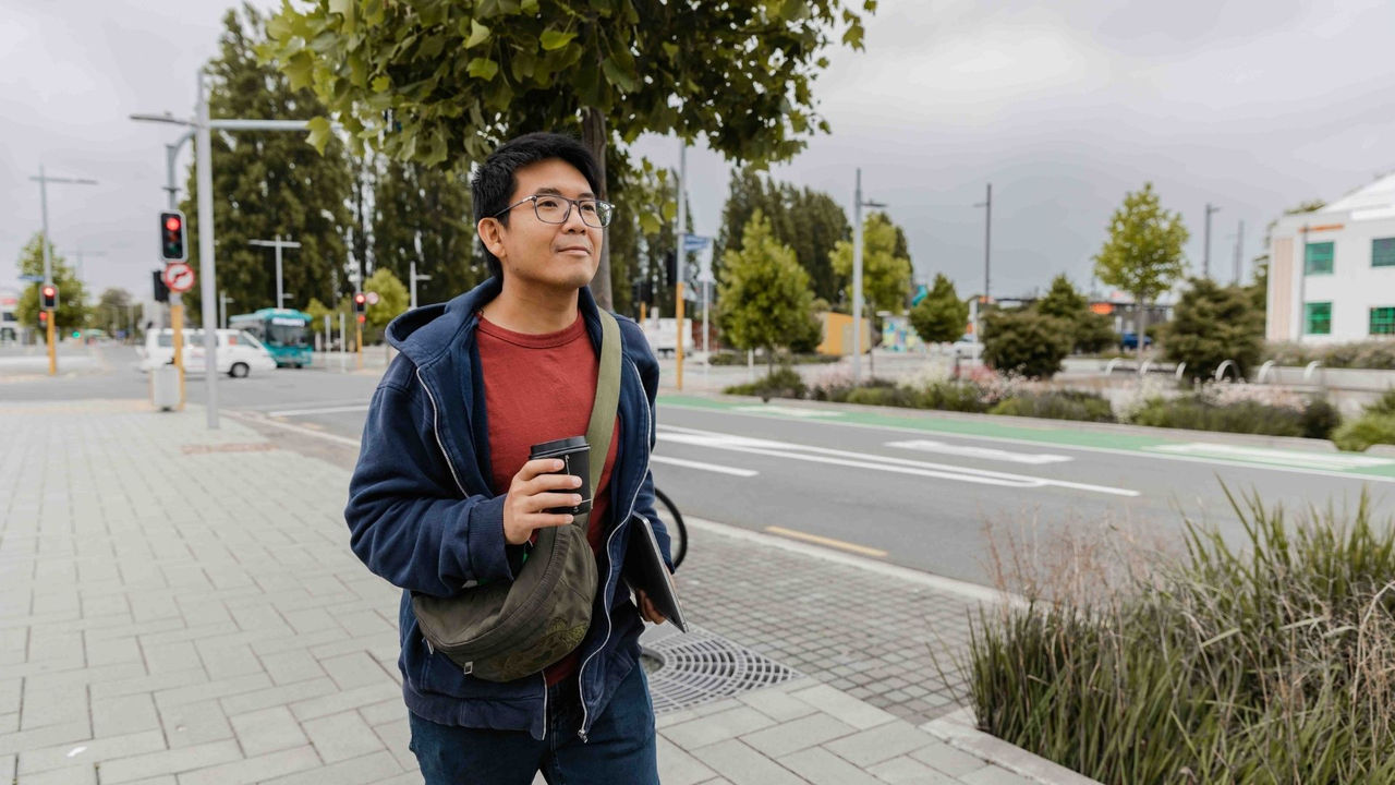 Clinical exercise physiologist walking through town after developing an exercise programme with a client