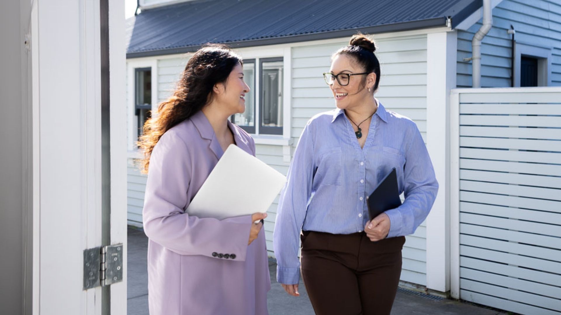 Two social workers walking together at a community placement after completing their Master of Social Work (Applied) through UC Online