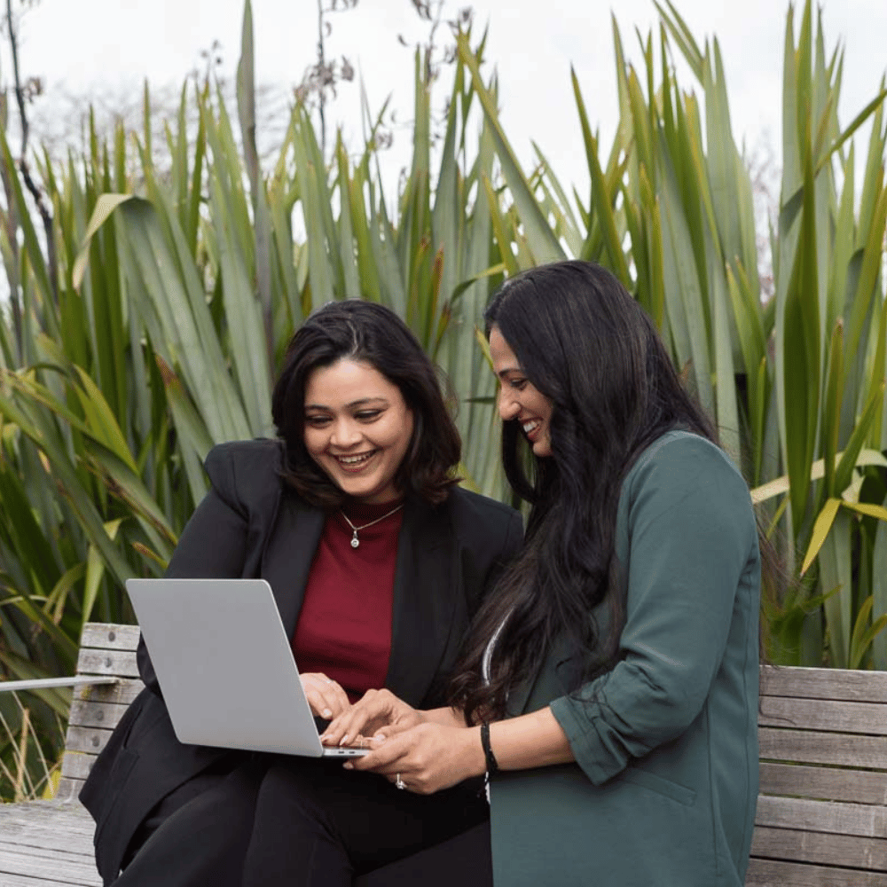 Two women studying sustainability outside with flexible online courses