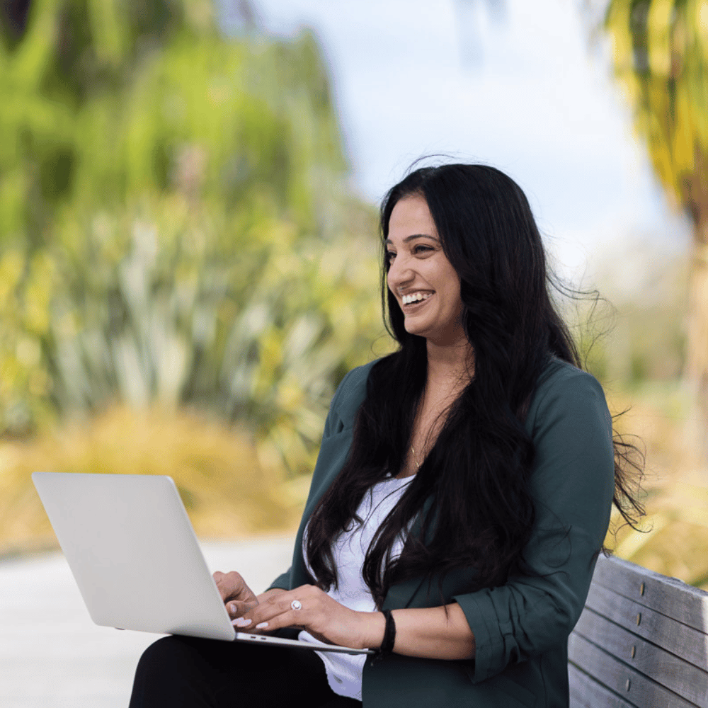 Female student studying sustainability online, viewing assignment on disruptive practices