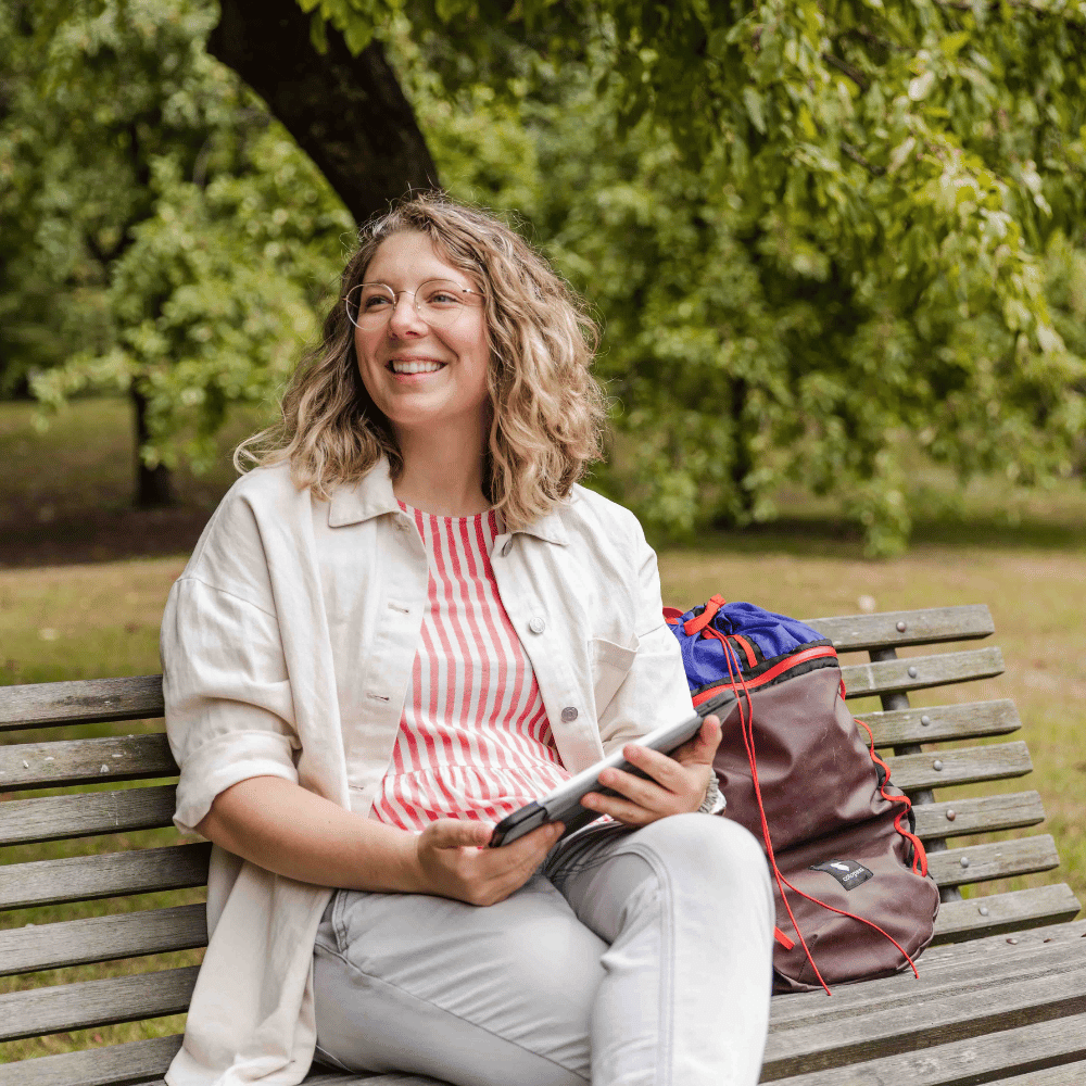 Learner sitting outside, engaging in an online climate change course