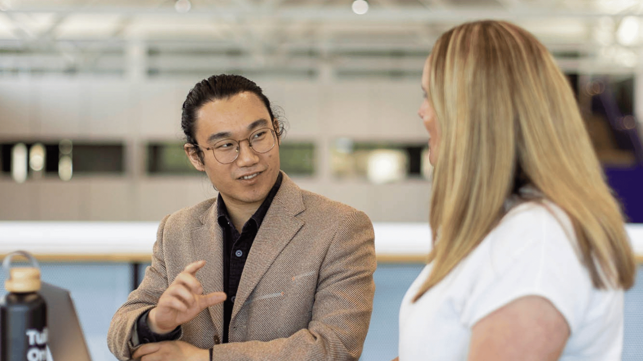  Two learners discussing UC Online group training. 