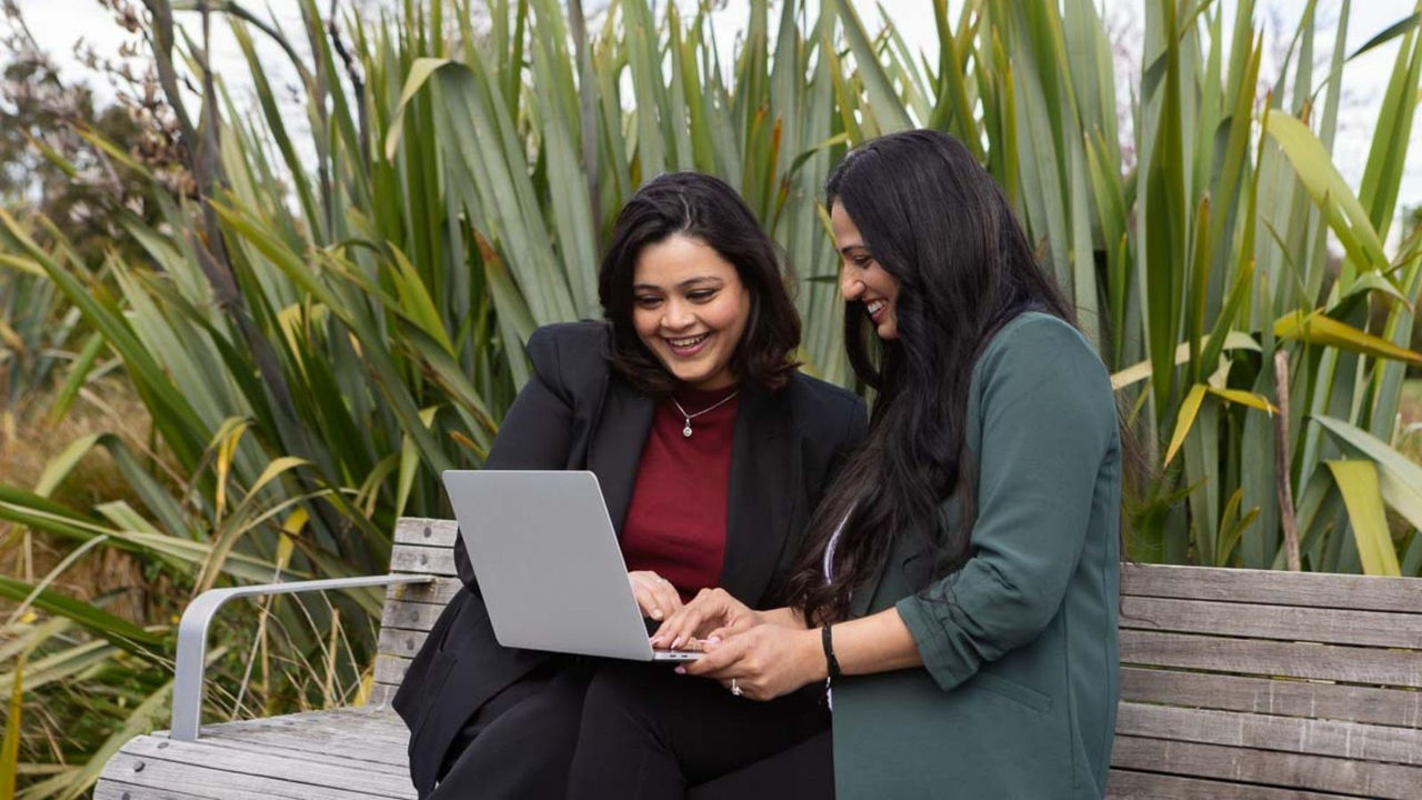 Two women completing their application for online study with UC online. 
