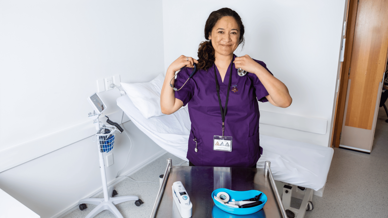 Nurse Prescriber smiling as she prepares a tray to support her patients. 