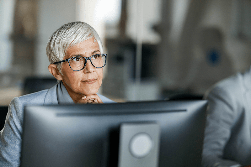 Woman at computer considering future study after finishing a Tuihono UC | UC Online micro-credential, looking at her cross-crediting and recognition of prior learning options. 