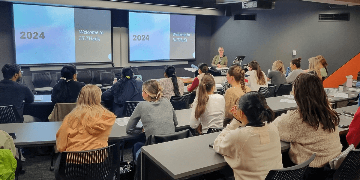 Isabel teaching learners during a 2024 Master of Health Sciences in-person intensive